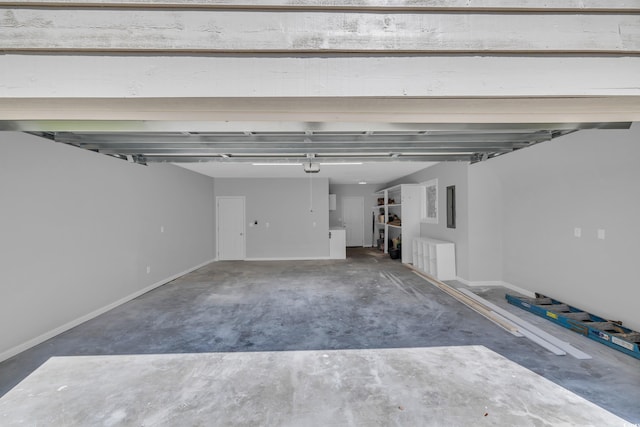 garage with baseboards and a garage door opener