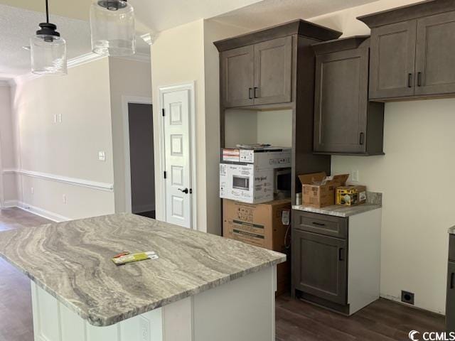 1397 Knotty Branch Rd, Conway, SC 29527 - kitchen featuring dark wood-type flooring, light stone countertops, decorative light fixtures, and a kitchen island