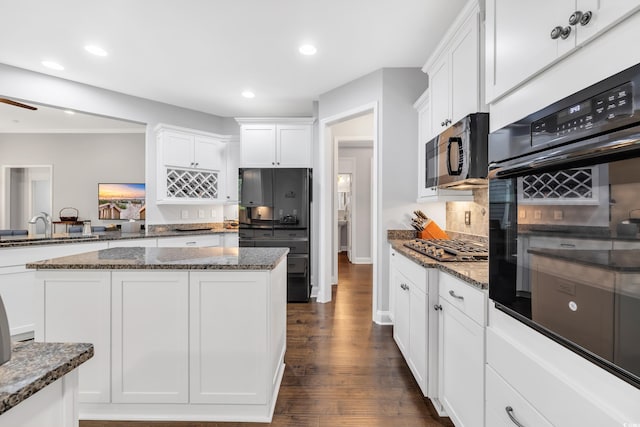 1478 Suncrest Dr, Myrtle Beach, SC 29577 - kitchen with black appliances, white cabinetry, dark stone countertops, a sink, and recessed lighting