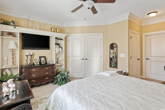 bedroom featuring a closet, ornamental molding, carpet floors, and ceiling fan