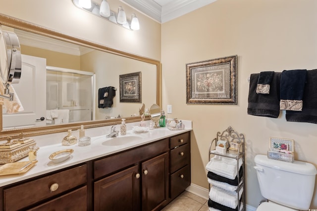 bathroom featuring tile patterned flooring, vanity, toilet, an enclosed shower, and ornamental molding