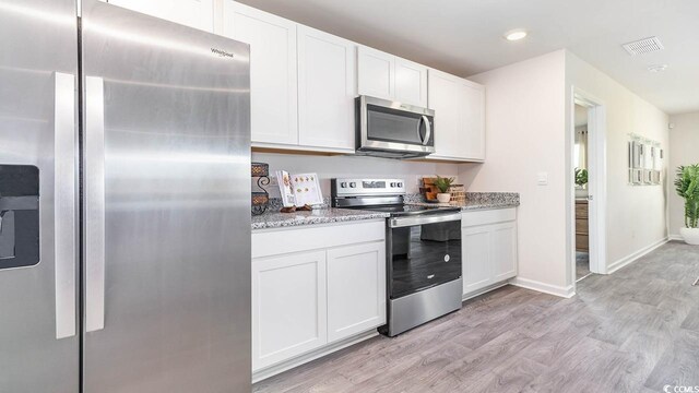 193 Country Grove Way, Galivants Ferry, SC 29544 - kitchen with visible vents, white cabinets, stainless steel appliances, and light wood-type flooring