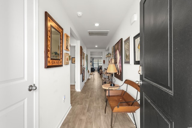 corridor featuring recessed lighting, light wood finished floors, visible vents, and baseboards