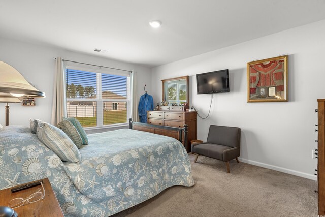 bedroom with visible vents, baseboards, and carpet