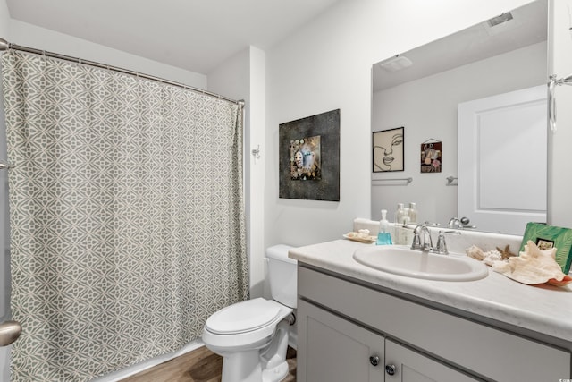 full bathroom with toilet, curtained shower, vanity, and wood finished floors