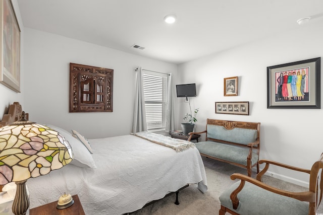 carpeted bedroom featuring baseboards and visible vents