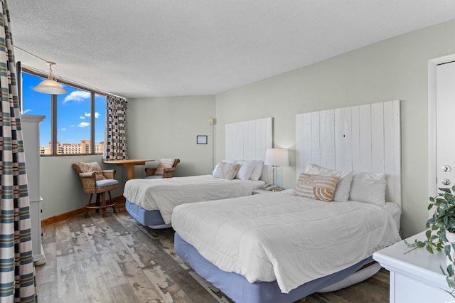 9550 Shore Dr Unit 1518, Myrtle Beach, SC 29572 - bedroom with wood finished floors, baseboards, and a textured ceiling