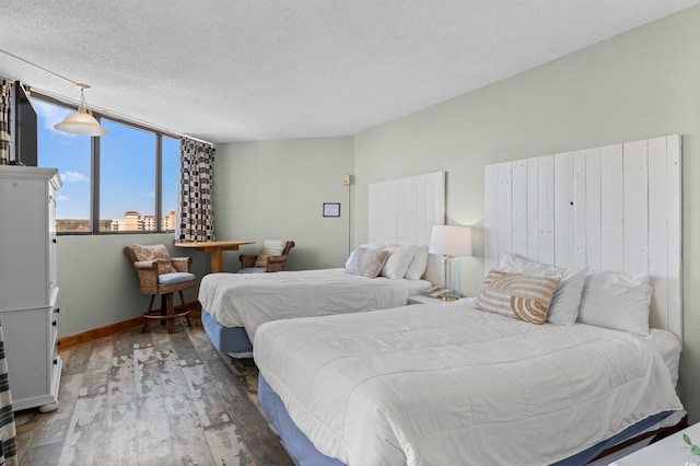 9550 Shore Dr Unit 1518, Myrtle Beach, SC 29572 - bedroom with wood finished floors, baseboards, and a textured ceiling