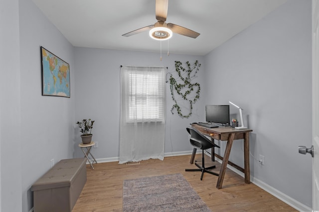 home office featuring a ceiling fan, baseboards, and wood finished floors