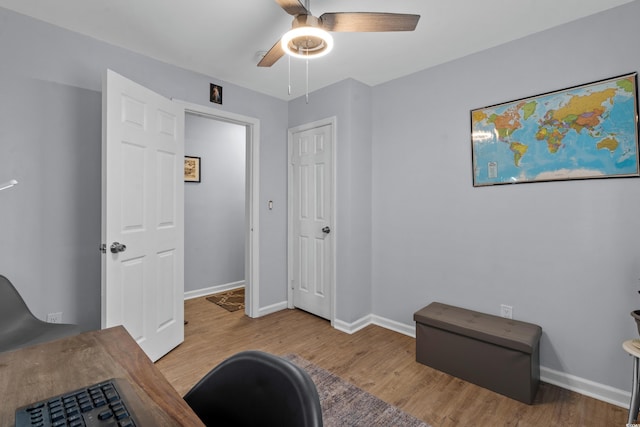 interior space with ceiling fan, baseboards, and wood finished floors