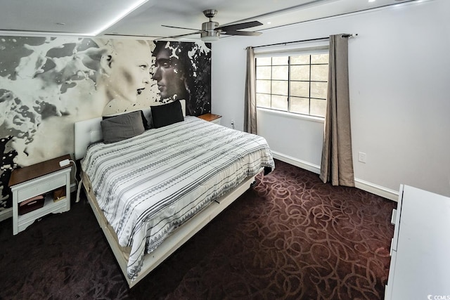 bedroom featuring baseboards, ceiling fan, and carpet