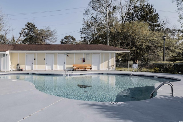 pool featuring fence and a patio area