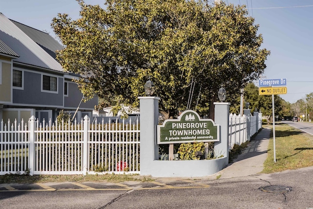 community / neighborhood sign with fence