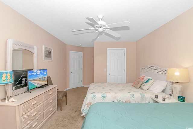 bedroom with ceiling fan and light carpet