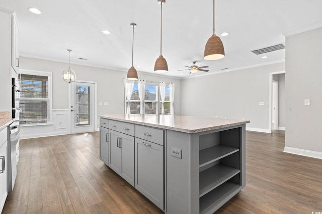 5885 Ledro Ln, Myrtle Beach, SC 29572 - kitchen featuring open shelves, gray cabinets, dark wood-style flooring, a center island, and crown molding