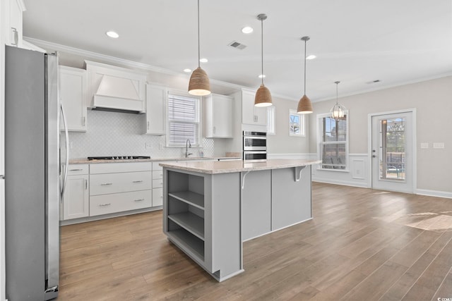 5885 Ledro Ln, Myrtle Beach, SC 29572 - kitchen featuring stainless steel appliances, premium range hood, open shelves, white cabinets, and crown molding