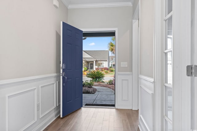 5885 Ledro Ln, Myrtle Beach, SC 29572 - foyer with ornamental molding, a decorative wall, wood finished floors, and wainscoting