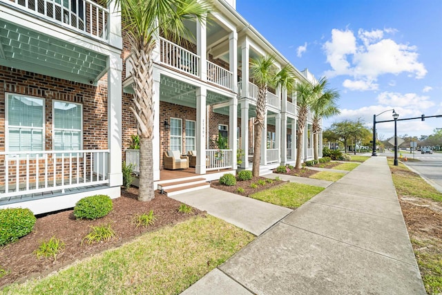 2790 Howard Ave Unit D, Myrtle Beach, SC 29577 - property entrance with covered porch, brick siding, and a balcony