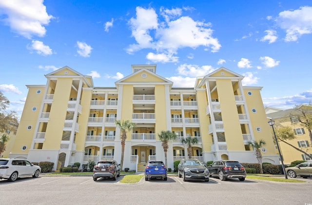 view of building exterior featuring uncovered parking