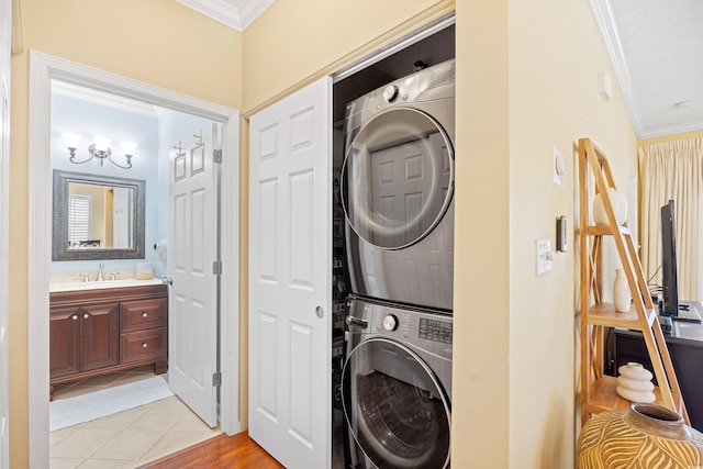 601 Hillside Dr N Unit 2305, North Myrtle Beach, SC 29582 - washroom with stacked washer and clothes dryer, crown molding, and light tile patterned floors