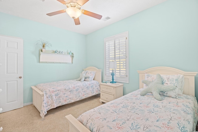 bedroom featuring carpet flooring, ceiling fan, and visible vents