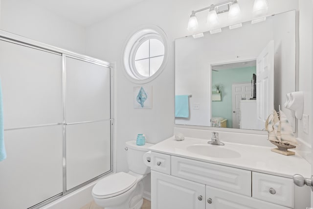 bathroom featuring an enclosed shower, vanity, toilet, and ensuite bath