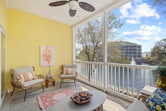 balcony with a ceiling fan and a water view