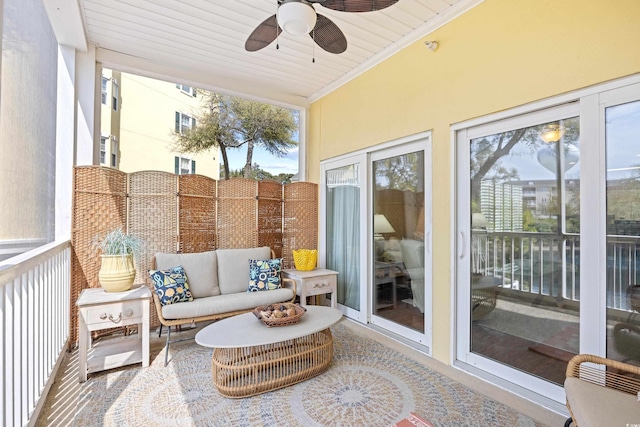 sunroom featuring outdoor lounge area and a ceiling fan