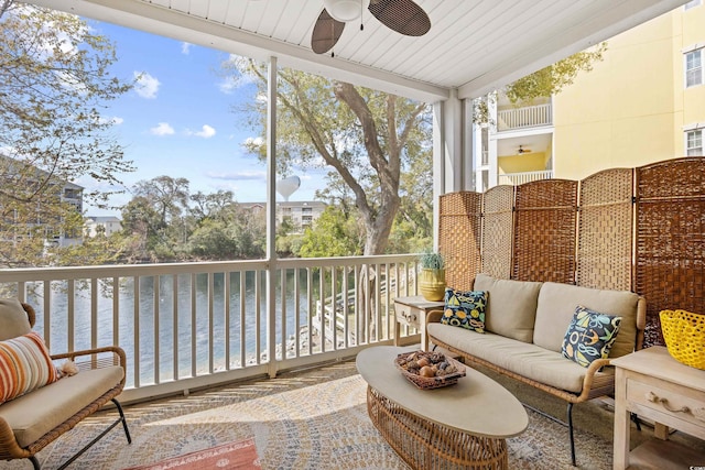 sunroom with plenty of natural light and a water view