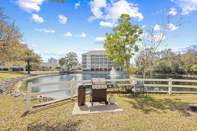 exterior space featuring a water view and fence