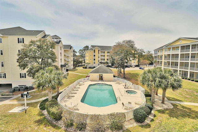pool with central AC unit, a hot tub, a patio area, and a yard