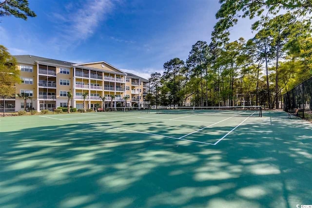 view of sport court featuring fence