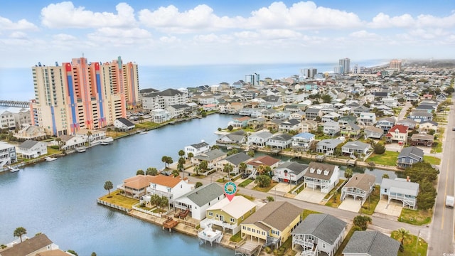 aerial view featuring a residential view, a water view, and a view of city
