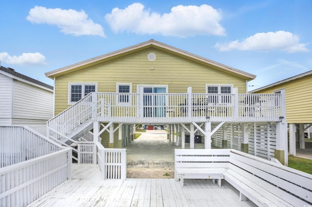rear view of property featuring stairs and a deck