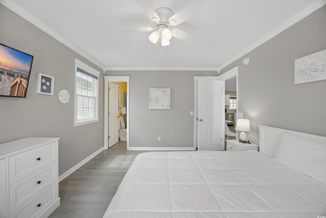 bedroom with wood finished floors, crown molding, baseboards, and a ceiling fan
