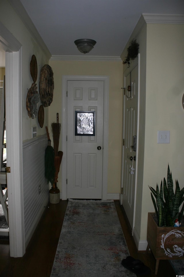 entryway featuring dark wood finished floors, baseboards, and ornamental molding