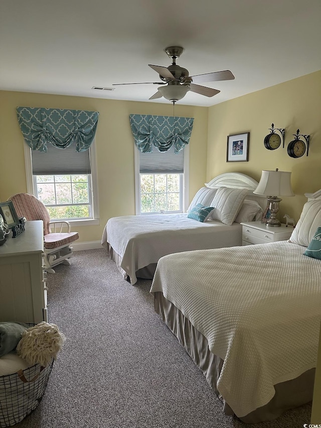 bedroom with ceiling fan, carpet floors, visible vents, and baseboards
