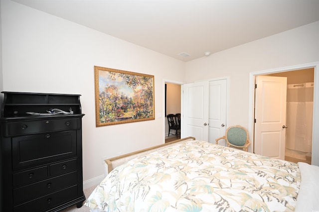 bedroom featuring baseboards, visible vents, and a closet