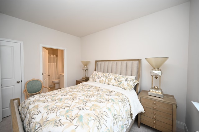 carpeted bedroom featuring ensuite bath