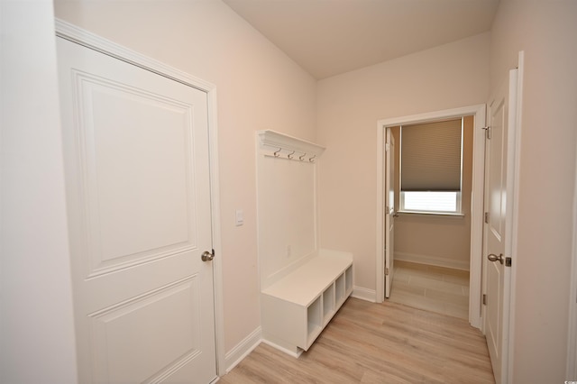 mudroom featuring baseboards and light wood finished floors