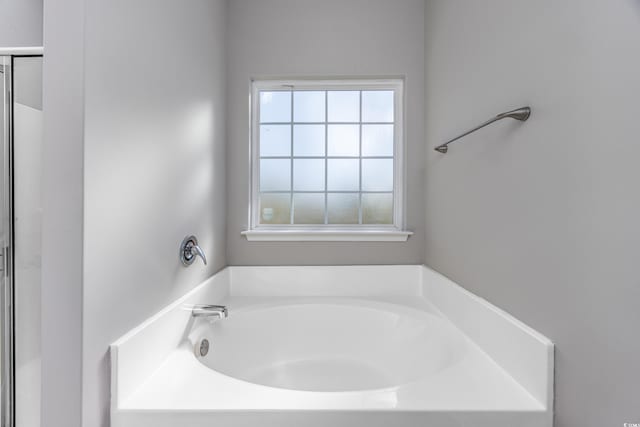 full bathroom with a shower with shower door and a bath