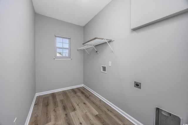 laundry area with wood finished floors, laundry area, electric dryer hookup, washer hookup, and baseboards