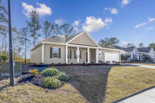view of front of property with concrete driveway, a porch, a front lawn, and an attached garage