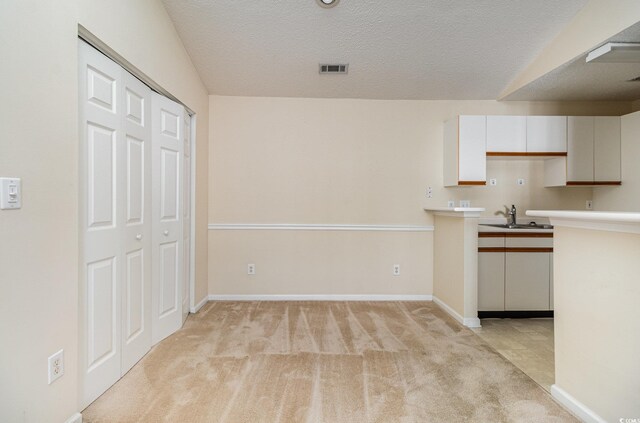 3795 Hitchcock Way Unit 637, Myrtle Beach, SC 29577 - kitchen featuring white cabinetry, light countertops, light colored carpet, a sink, and visible vents
