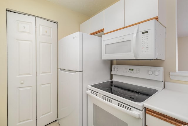 3795 Hitchcock Way Unit 637, Myrtle Beach, SC 29577 - kitchen featuring white appliances, light countertops, a textured ceiling, and white cabinets