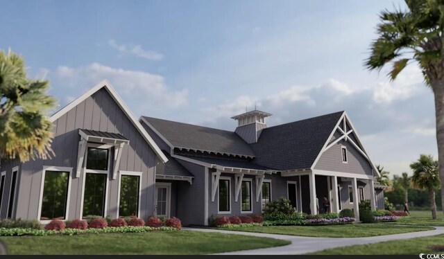 exterior space with board and batten siding and a front yard