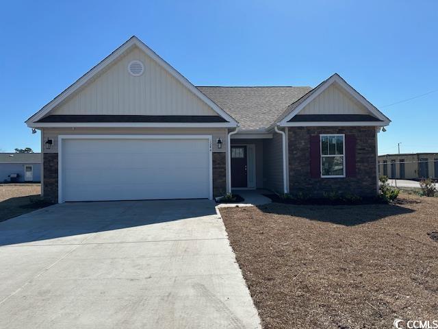 single story home with concrete driveway, stone siding, and a garage