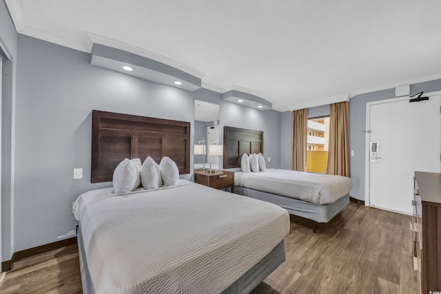 bedroom with crown molding, wood finished floors, baseboards, and recessed lighting