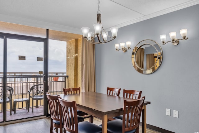 dining space featuring a chandelier, wood finished floors, crown molding, and a wall of windows
