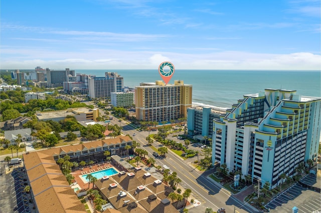 view of urban area with a pool area and a nearby body of water